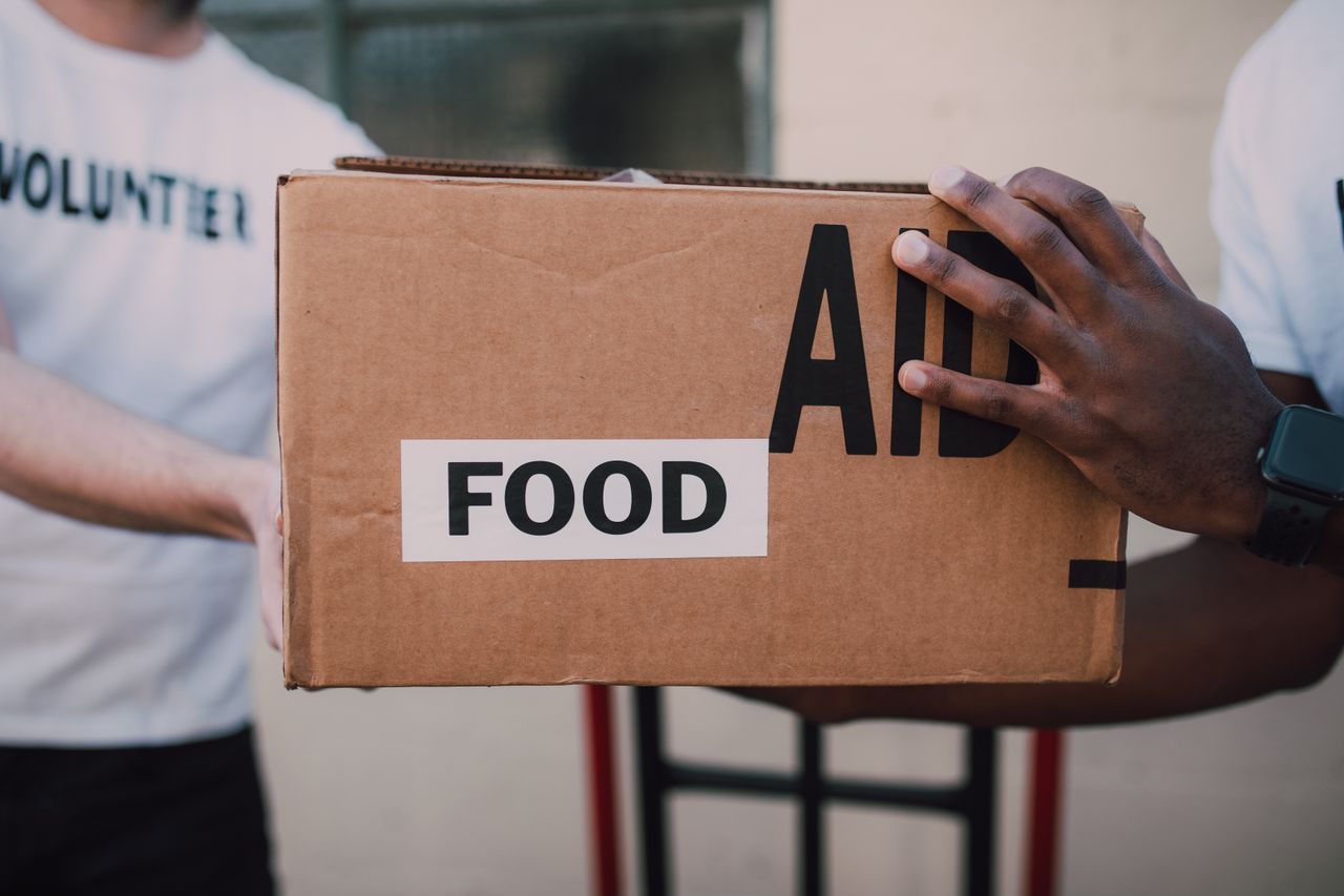 Community outreach — volunteers distributing food aid