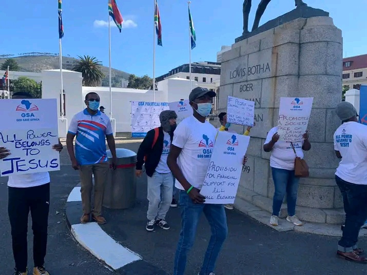 GSAW volunteers marching with signs calling for small business support